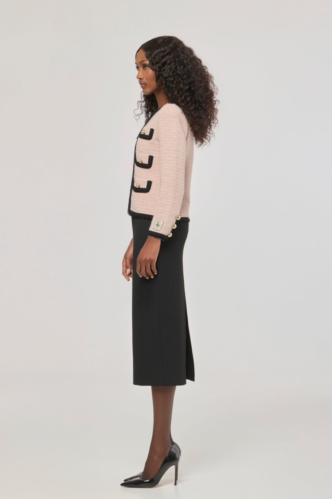 Chaqueta corta de punto rosa para mujer Preston, con ribetes negros en contraste y botones dorados.