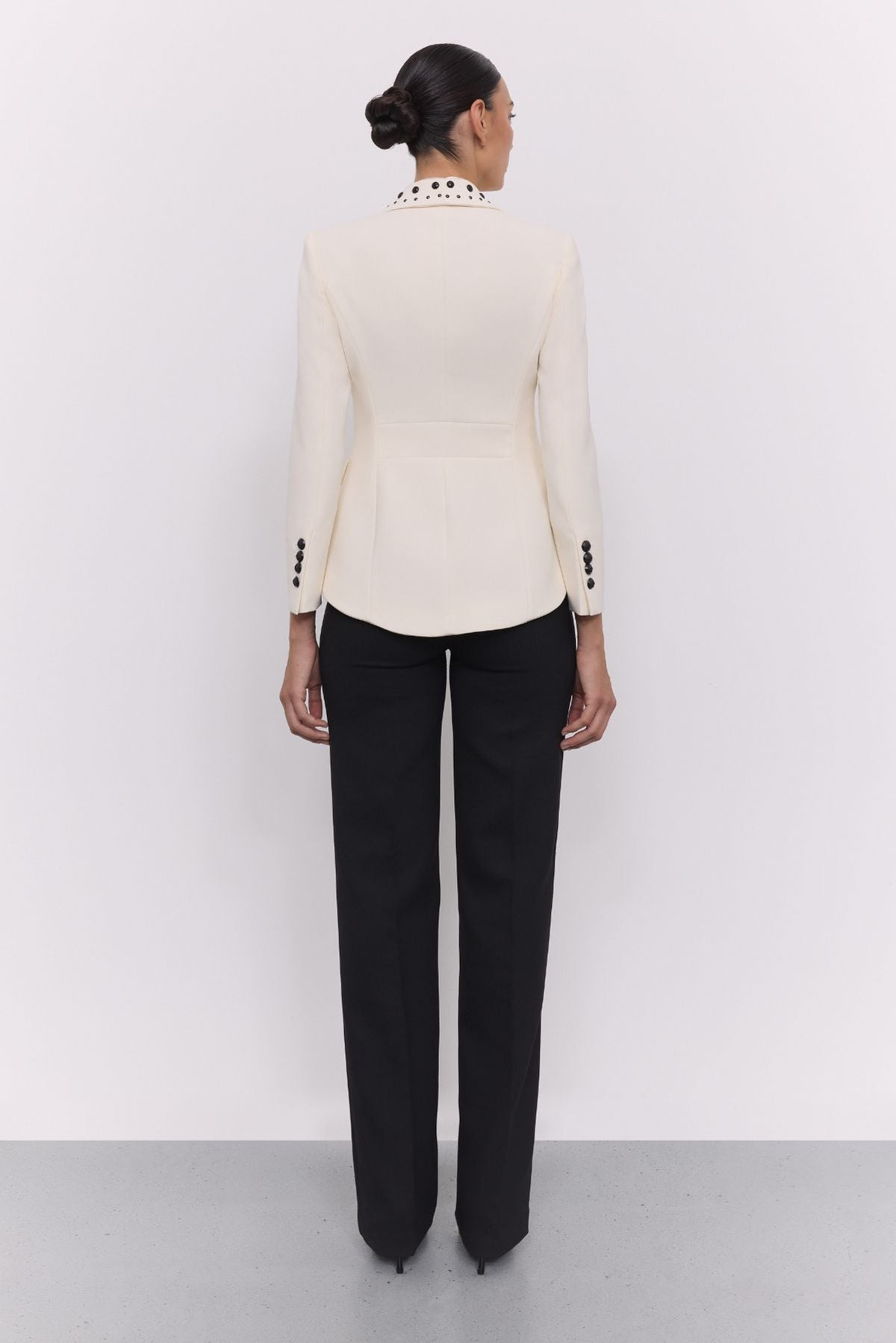 Blazer tachas marfil Eleanore en super crepe color marfil con solapa smoking, detalles de tachas negras colocadas a mano.